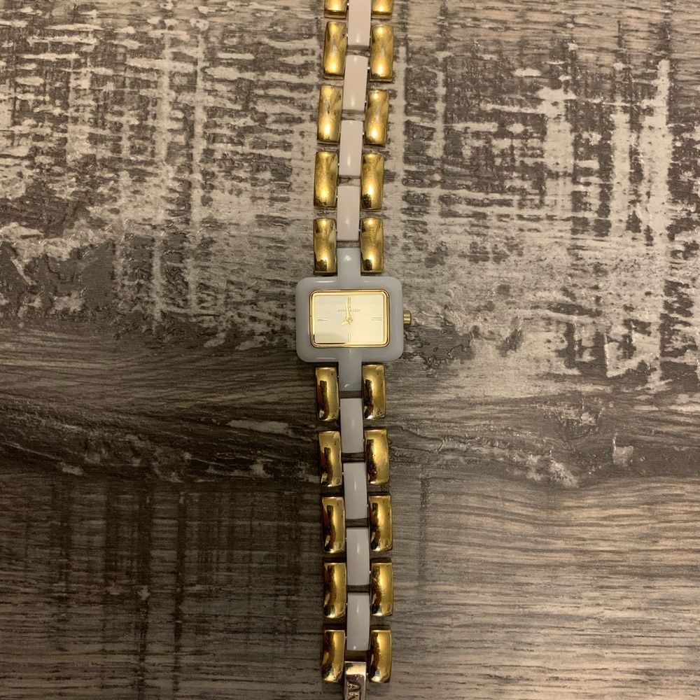 women’s gold and white Anne Klein watch